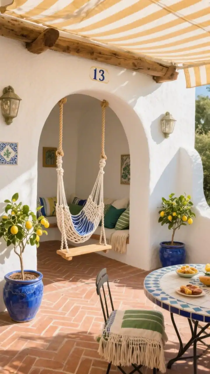 Corner-angle wide shot, Sunny Mediterranean Courtyard Swing Nook: terra pavers laid in a herringbone pattern; a stucco arch framing a double swing beam with thick cotton rope; a macramé hammock swing and a classic plank swing; cobalt ceramic pots with lemon trees; a tile-top bistro table with snacks; striped awning fabric stretched overhead for shade; Mediterranean tile cushions and tasseled throws; hand-painted house numbers on the beam; warm, sun-bleached white and terracotta tones with cobalt and olive green accents; golden afternoon light, photorealistic.