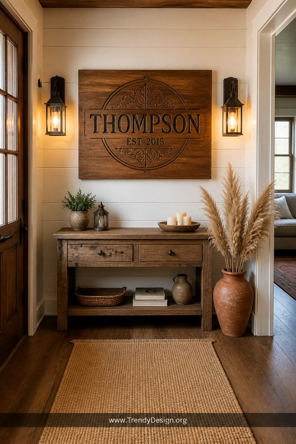 Wide entryway shot of a warm farmhouse foyer featuring a large CNC-engraved rustic cedar wood family name sign with an establ