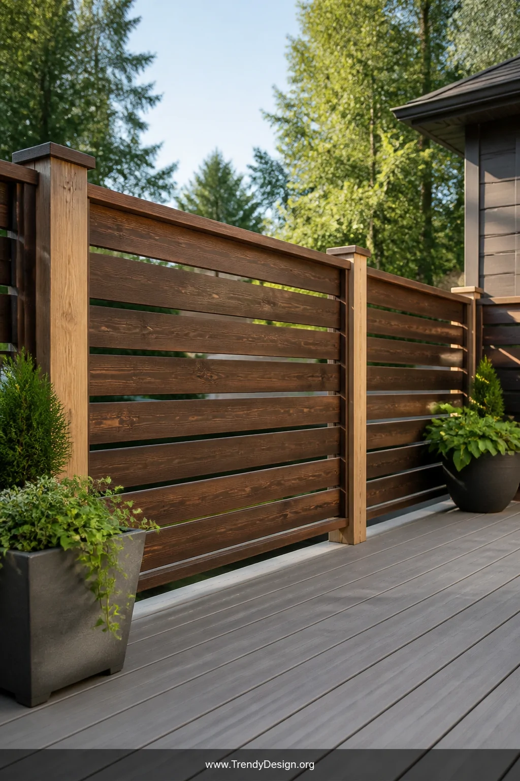 A wide-angle photorealistic shot of a modern deck railing built from smooth horizontal pallet boards stained in warm walnut t