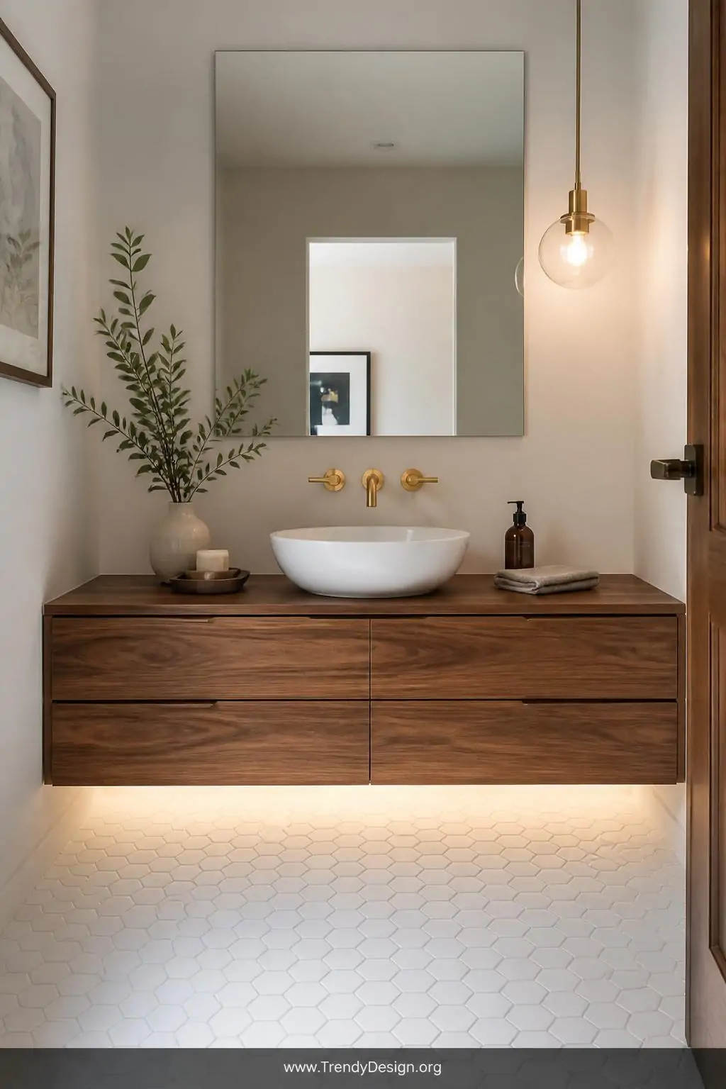 Medium shot of a modern floating vanity in warm walnut wood hovering six inches above a glossy white hexagon tile floor, a sc