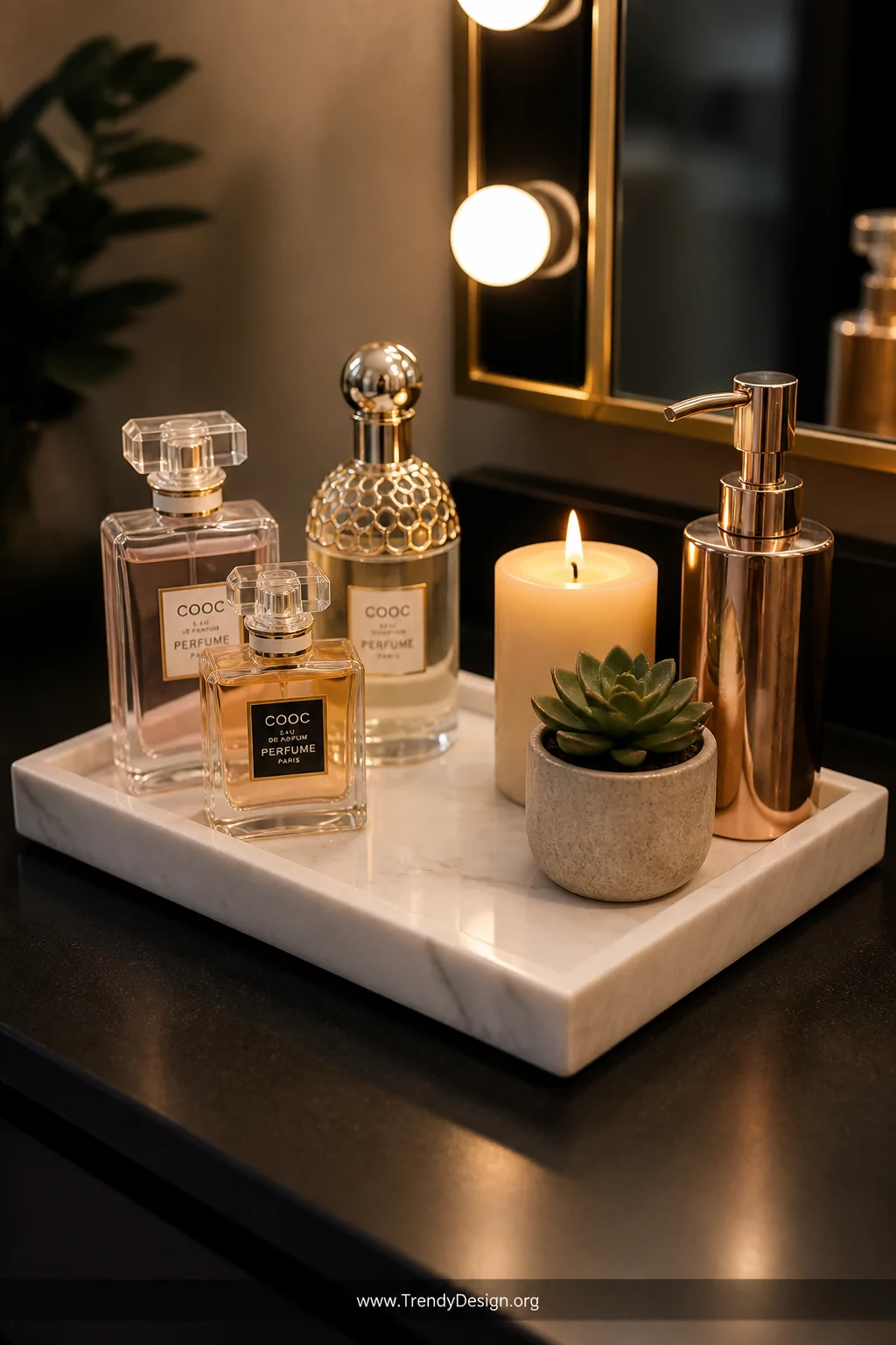 Medium closeup of a small honed white marble vanity tray on a matte black bathroom counter, styled with three glass perfume b