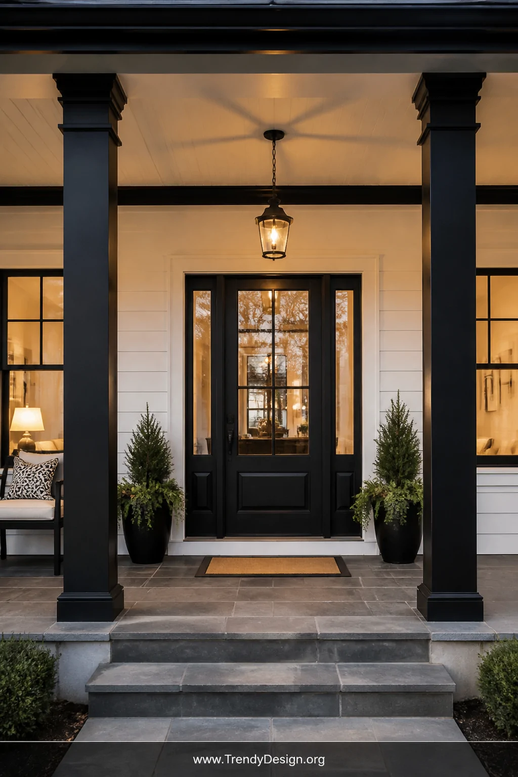 Medium shot of a classic front porch facade showcasing bold matte black painted structural columns and overhead beams as dram