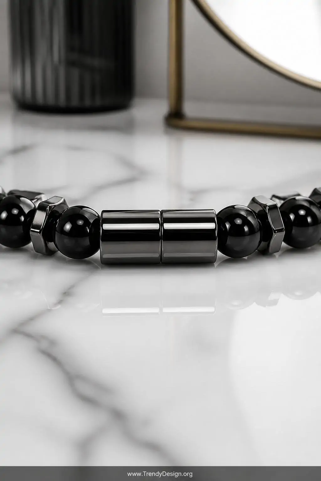 A sleek white marble vanity surface showcases two powerful magnetic clasps snapping together on a modern gunmetal and obsidia