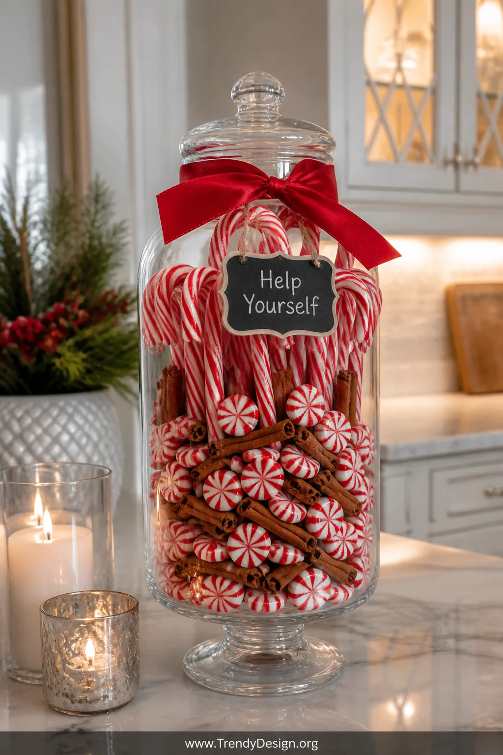 A medium shot of a tall glass apothecary jar densely packed with red and white peppermint candies and full-size candy canes s