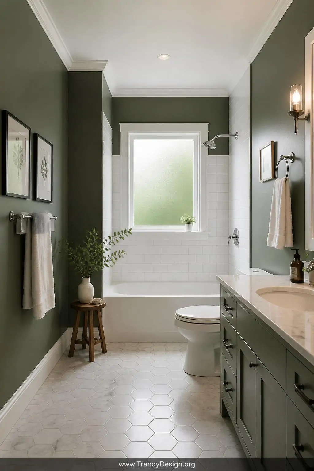 A serene bathroom interior painted in deep sage green with white trim, the matte walls contrasting beautifully against existi