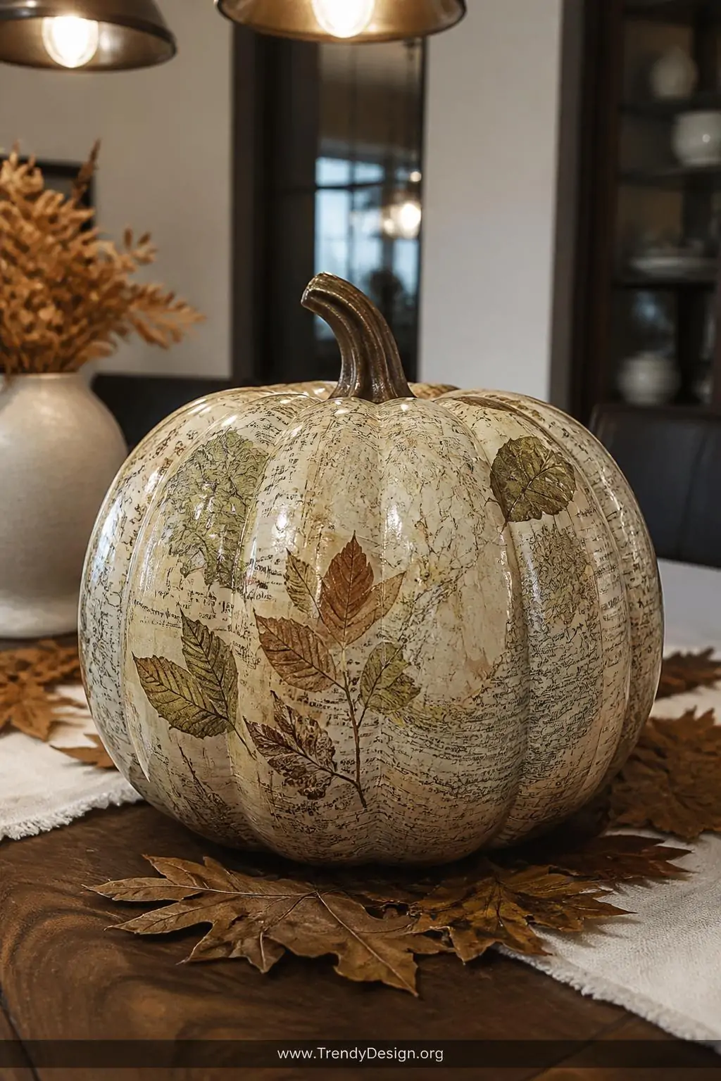 A closeup photorealistic interior shot of a decoupage pumpkin centerpiece on a dark walnut dining table, its surface wrapped 