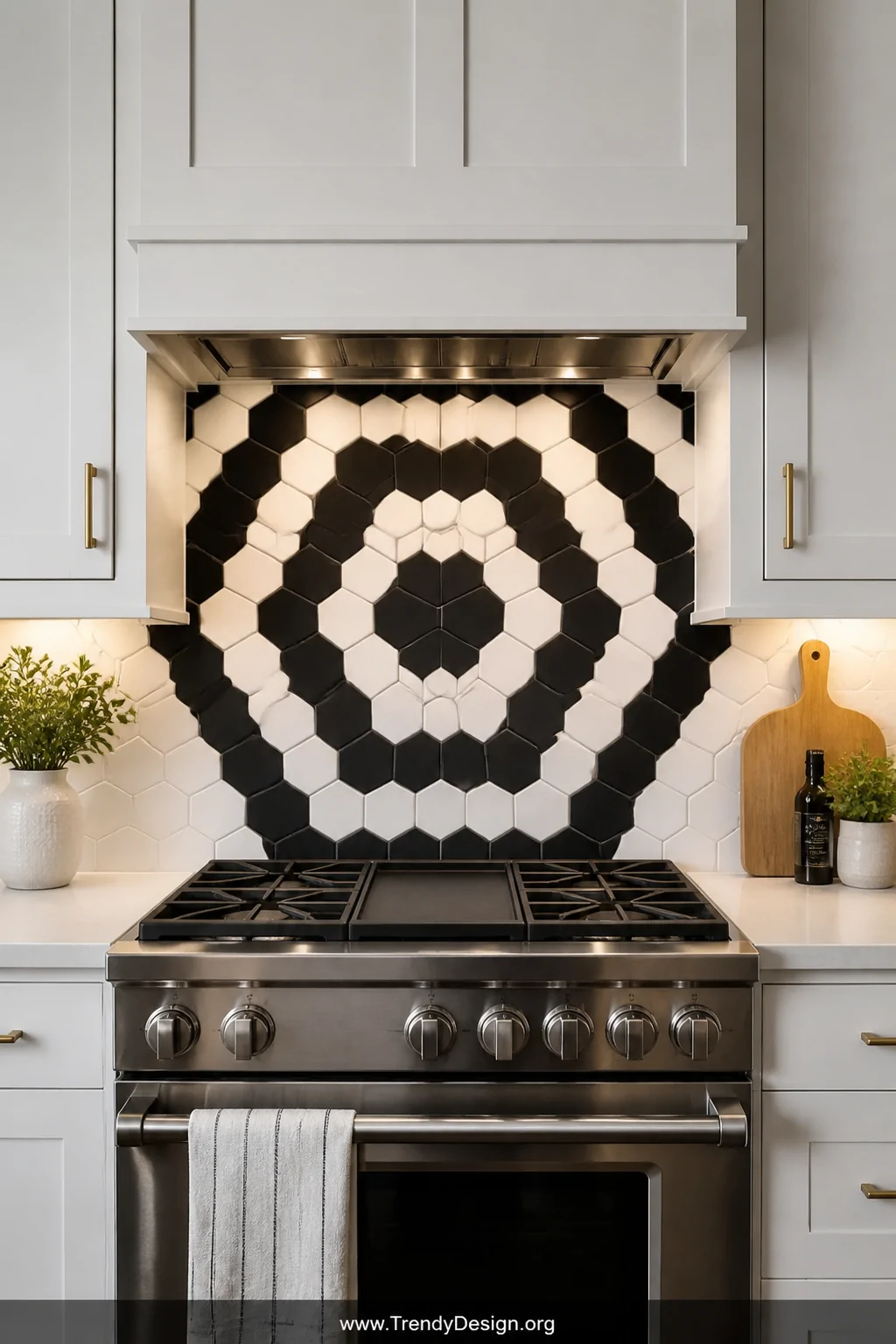Detail closeup of a dramatic black and white hexagon peel and stick tile backsplash centered perfectly behind a stainless ste