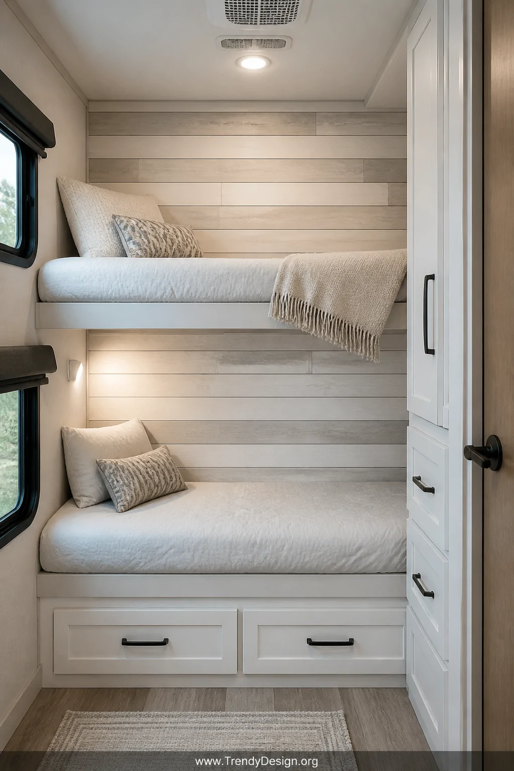 A wide photorealistic interior shot of an RV bunk room featuring a dramatic whitewashed shiplap accent wall installed directl
