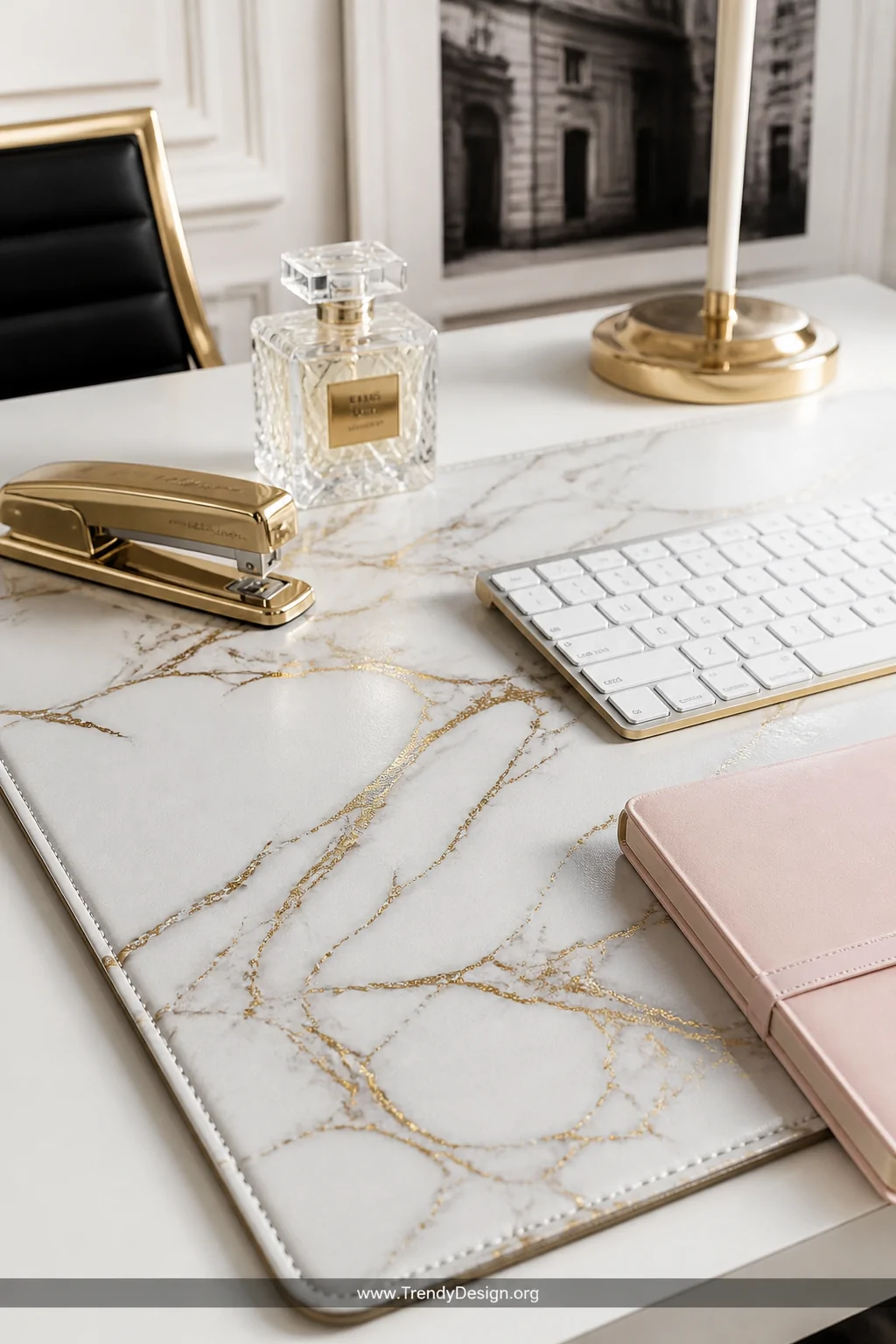 A close-up detail shot of a luxurious white and gold marble-print PU leather desk pad with elegant veining, styled with a gol