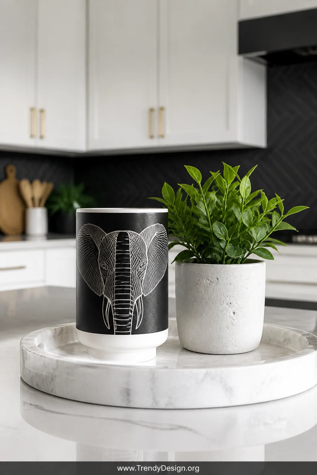 A detail shot of a crisp white marble tray on a contemporary kitchen counter holding a black and white graphic elephant tumbl
