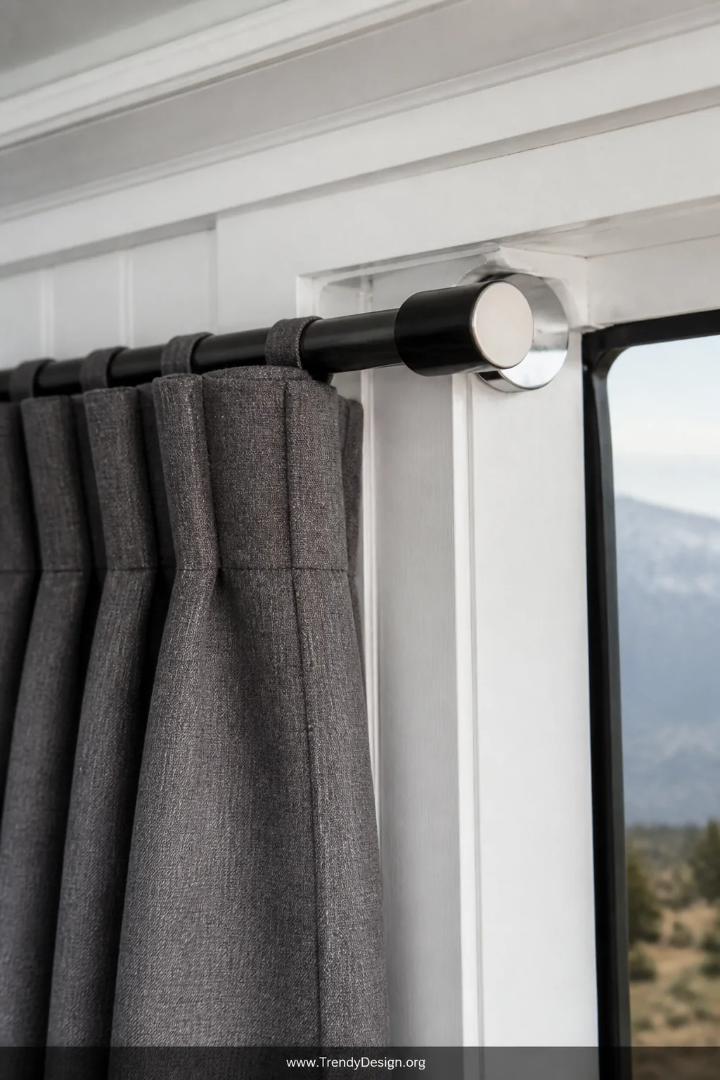 Detail closeup shot of an adjustable matte black tension rod mounted inside a pop-up camper window frame, neatly hung slate g