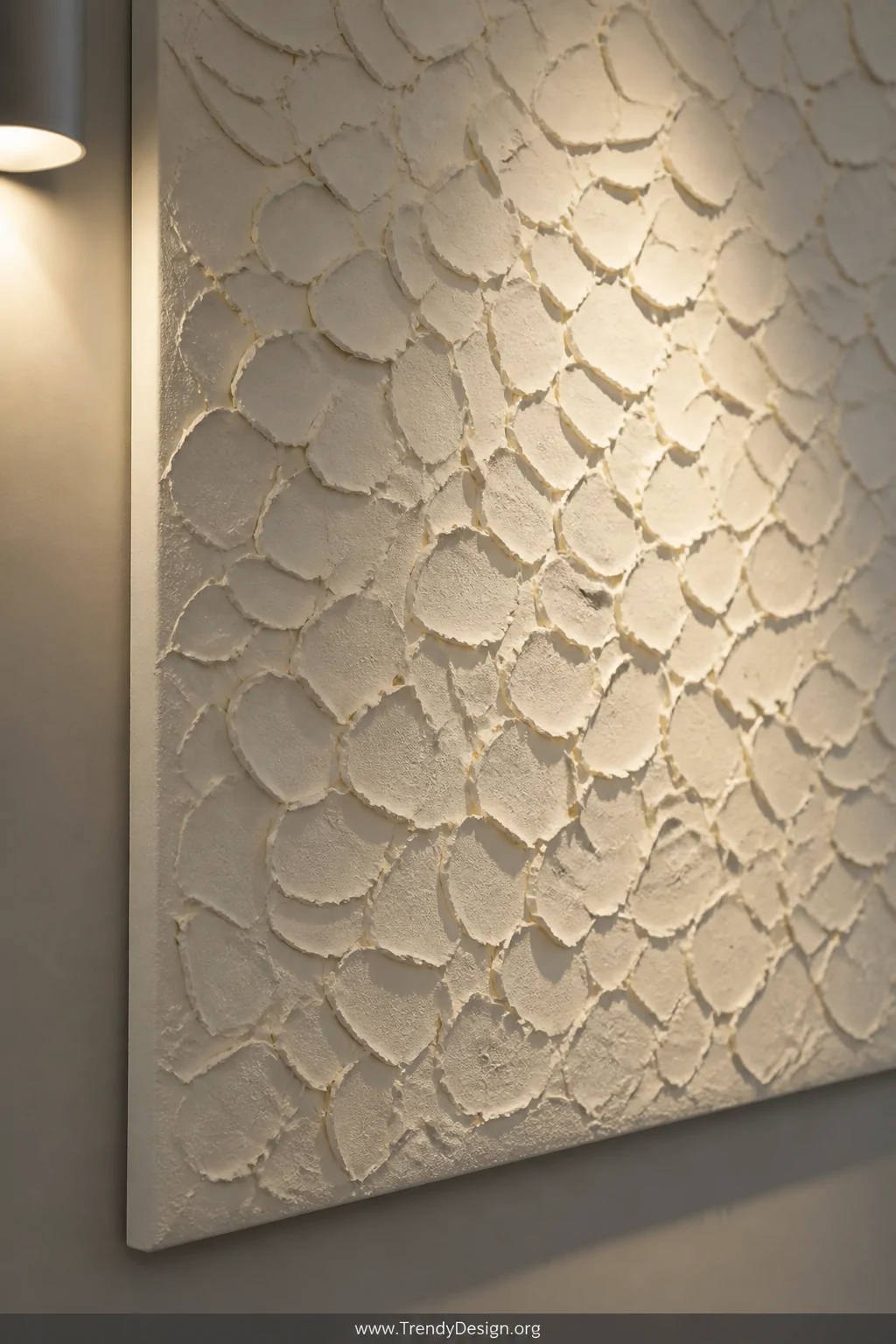 Close-up detail shot of a large canvas mounted on a light grey gallery wall, textured entirely with layered crushed eggshells
