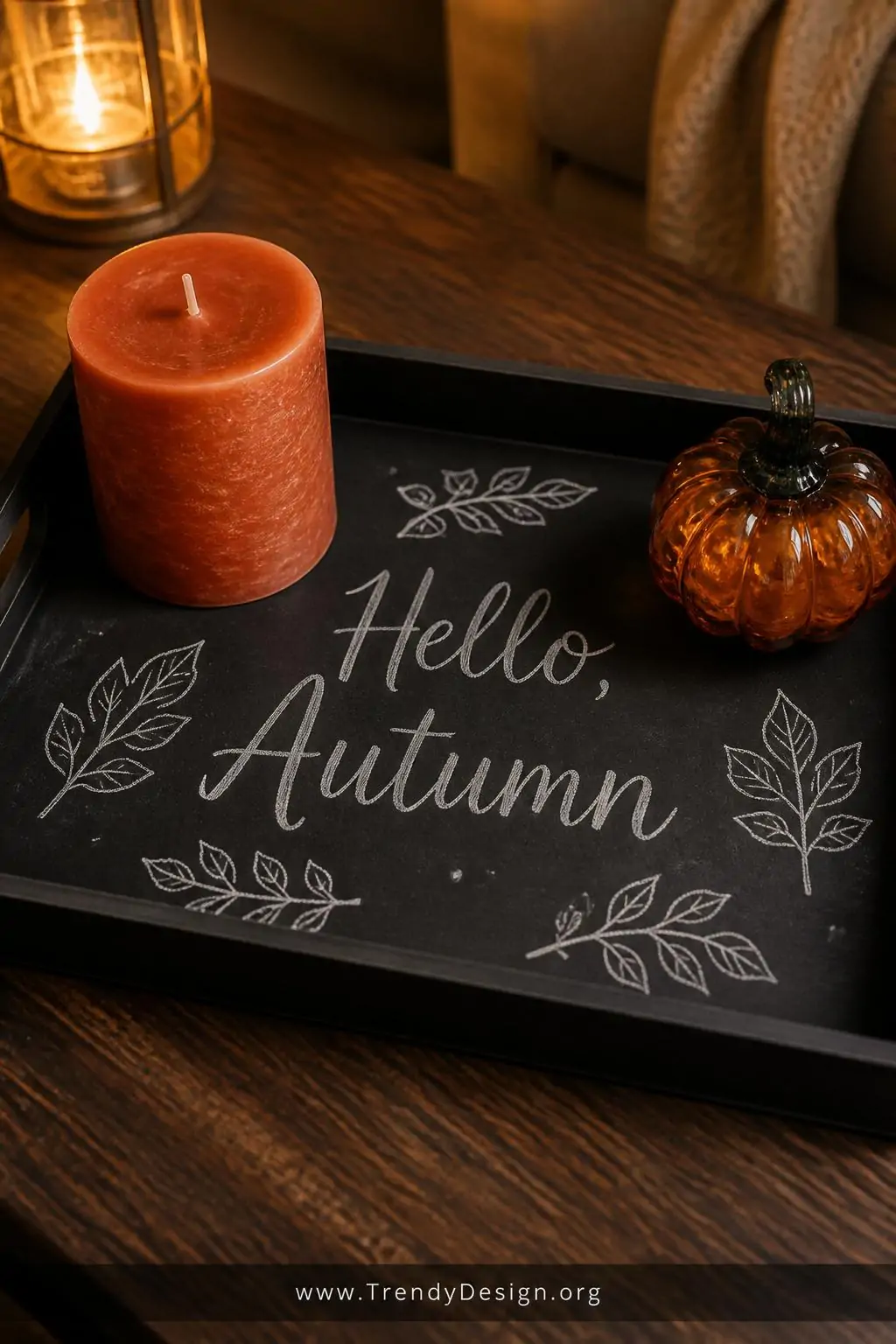Closeup shot of a matte black chalkboard-painted rectangular tray on a dark walnut coffee table surface, hand-lettered with e