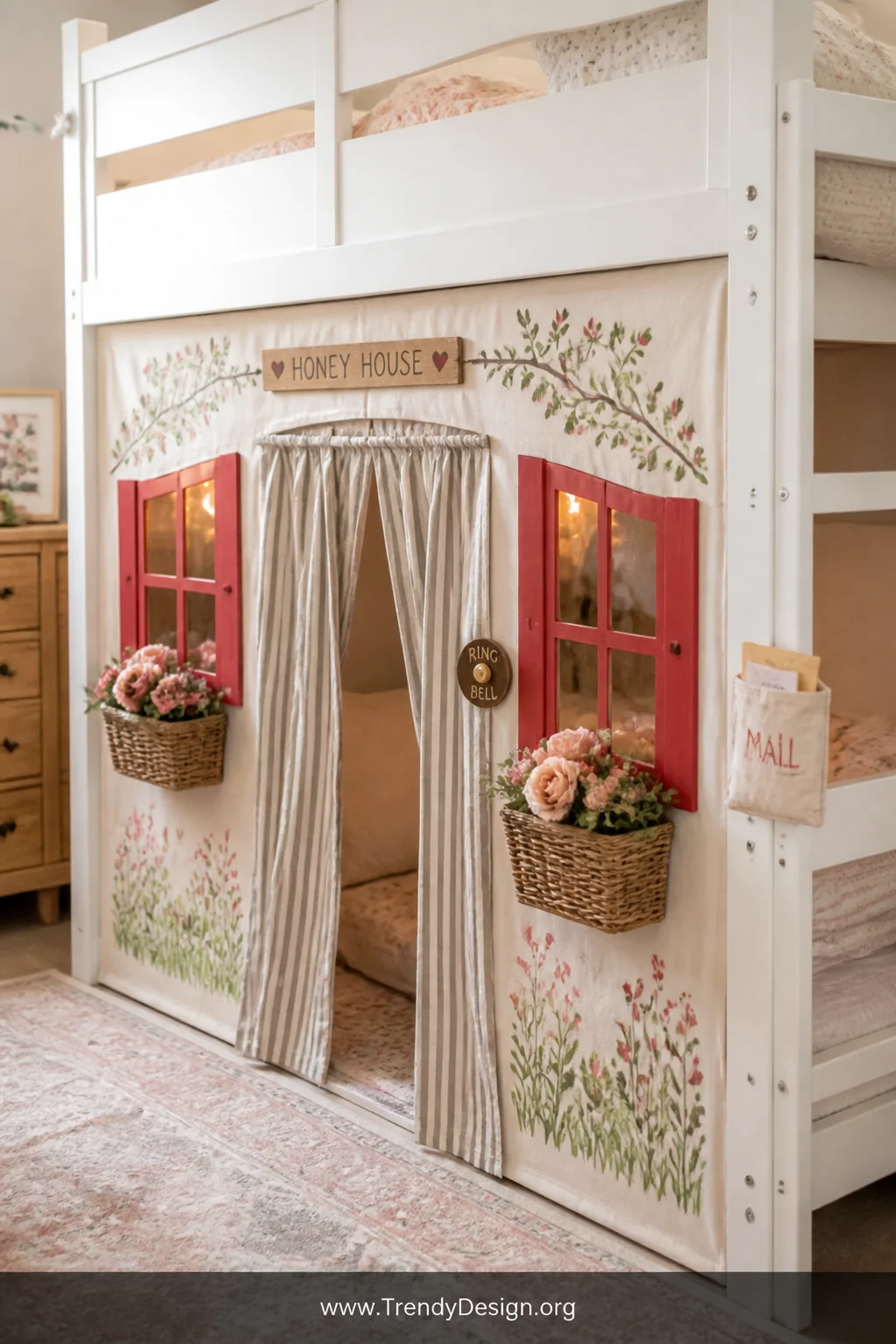 Medium shot of a bottom bunk fully dressed as a miniature playhouse with a hand-painted canvas facade panel featuring cheerfu