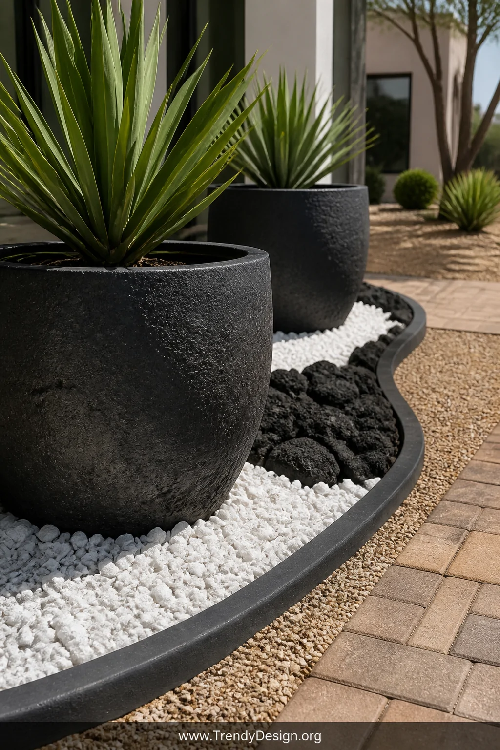 Medium photorealistic shot of large dark charcoal ceramic planters surrounded by white marble chip gravel and black lava rock