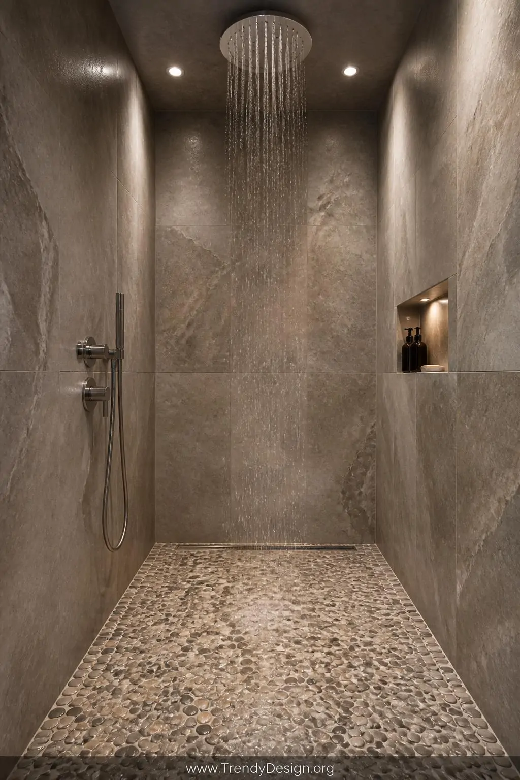 Wide-angle photorealistic interior design shot inside a fully enclosed walk-in shower clad entirely in cool grey limestone wa