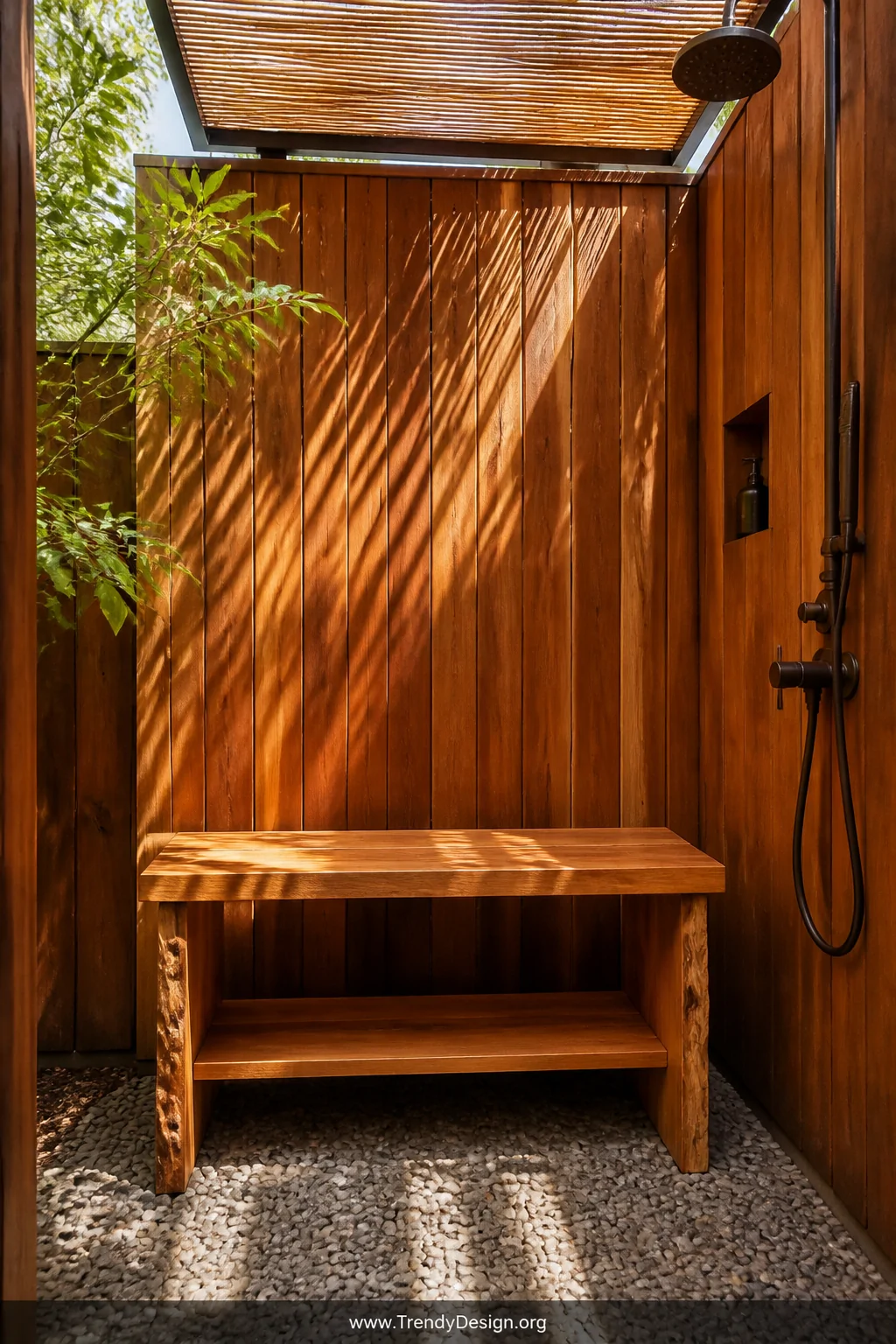Wide shot of a freestanding cedar wood bench with warm amber and honeyed orange tones set inside an outdoor shower enclosure 