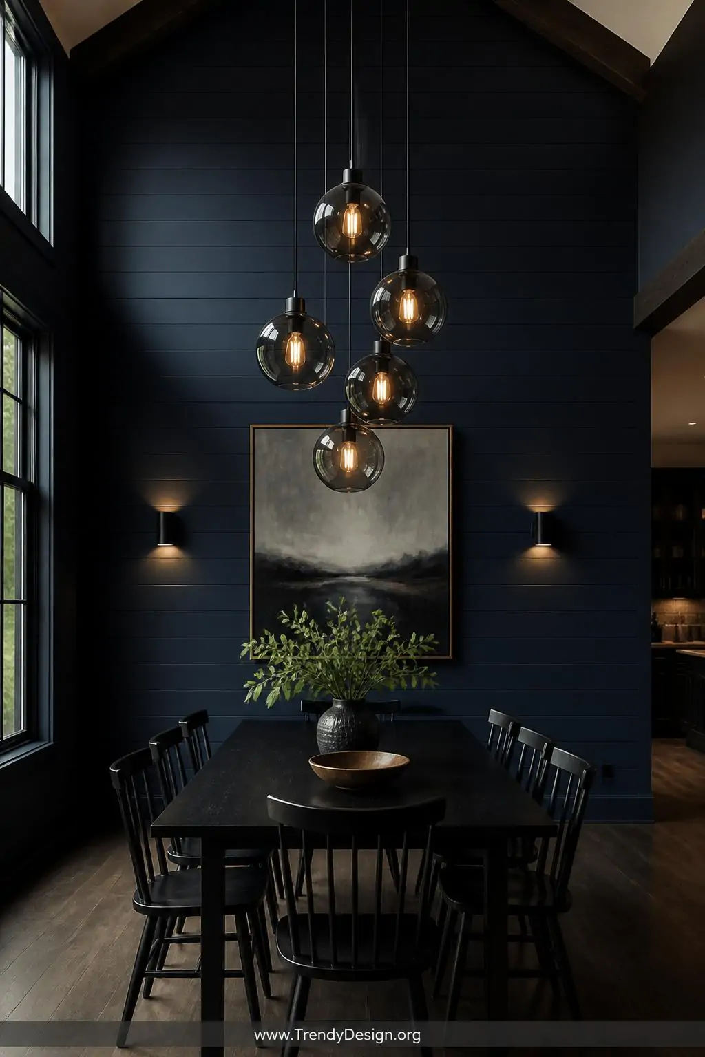 Wide shot of a clustered arrangement of five matching smoked black glass globe pendants dropped at varying heights between 6 