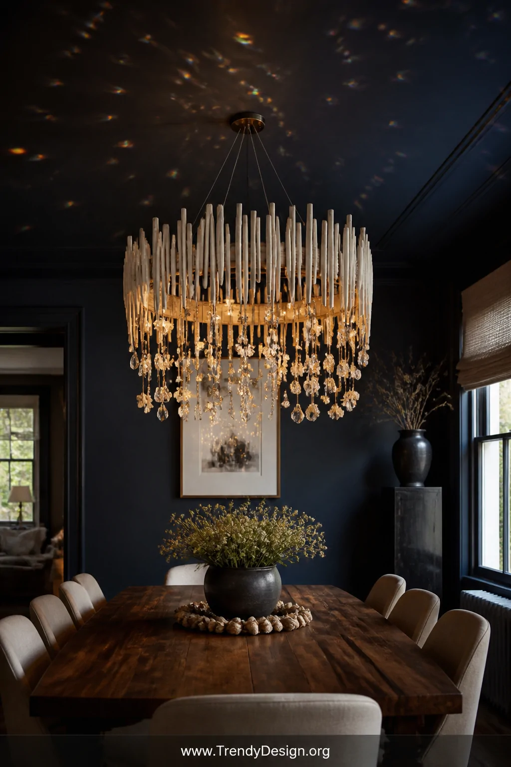A dreamy handmade stick chandelier suspended above a dark walnut dining table, constructed from a circular wire frame hung wi
