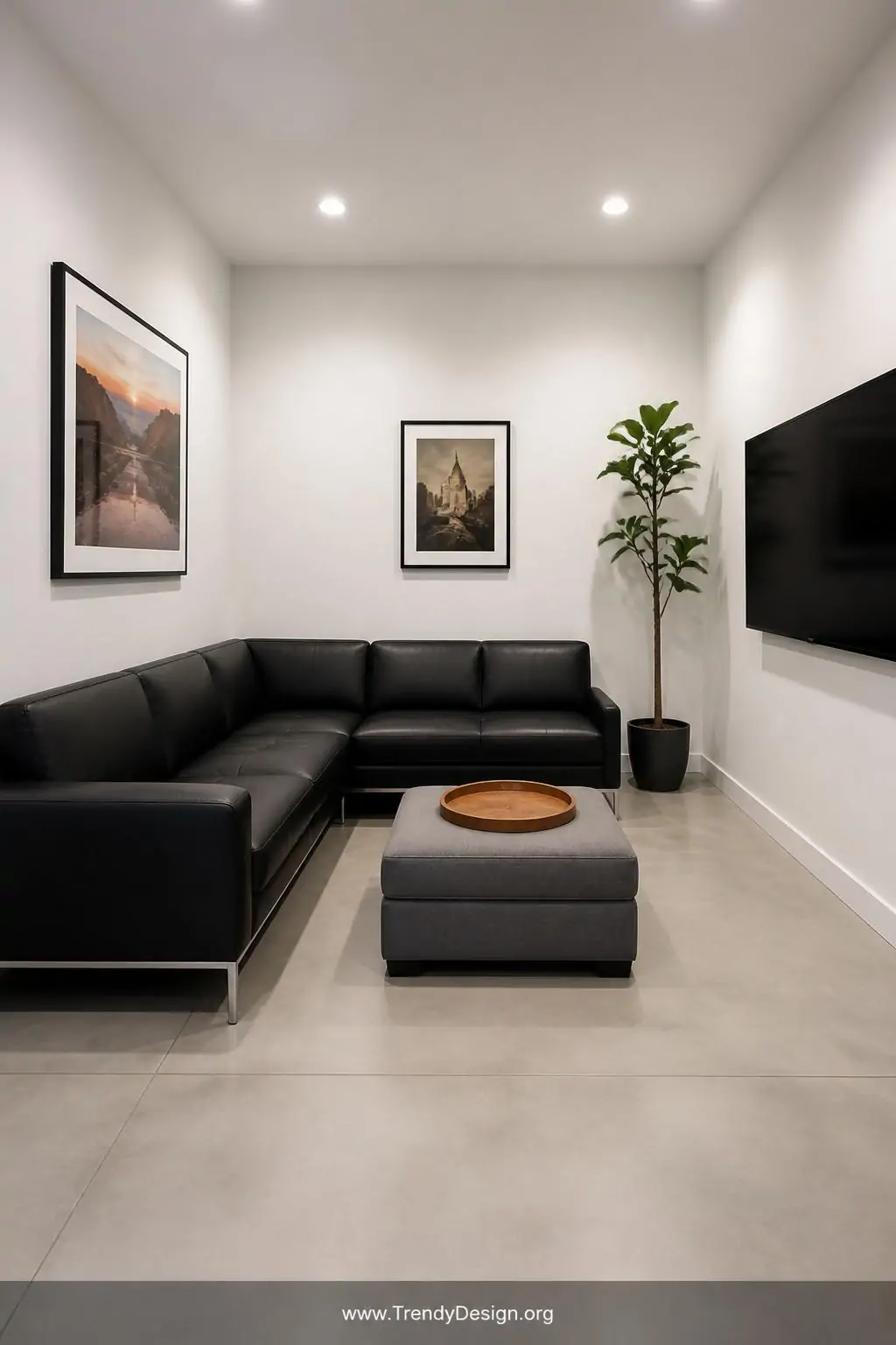 Photorealistic wide-angle interior photography of a small living room with a low-profile black leather L-shaped sectional wit