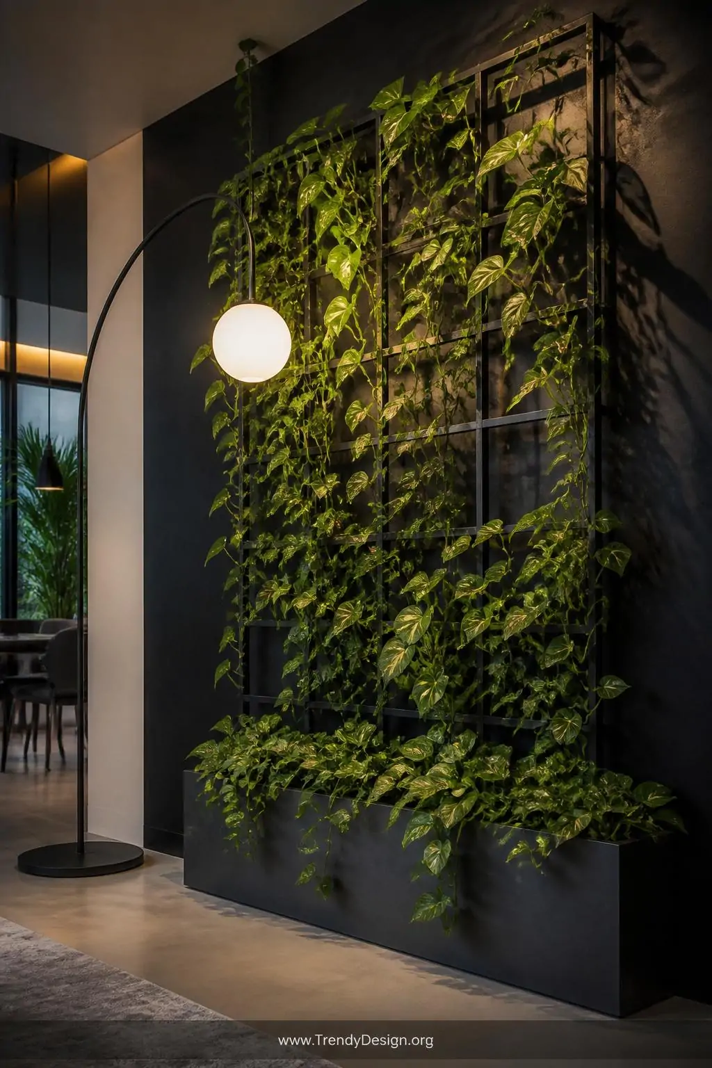Wide-shot photorealistic dramatic interior corner featuring a floor-to-ceiling black powder-coated metal trellis mounted with