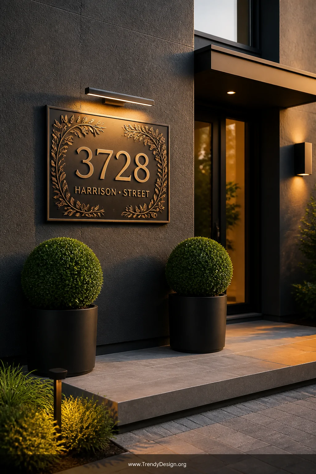 Medium exterior shot of a sophisticated home entrance featuring an oversized CNC-engraved coated aluminum address plaque with