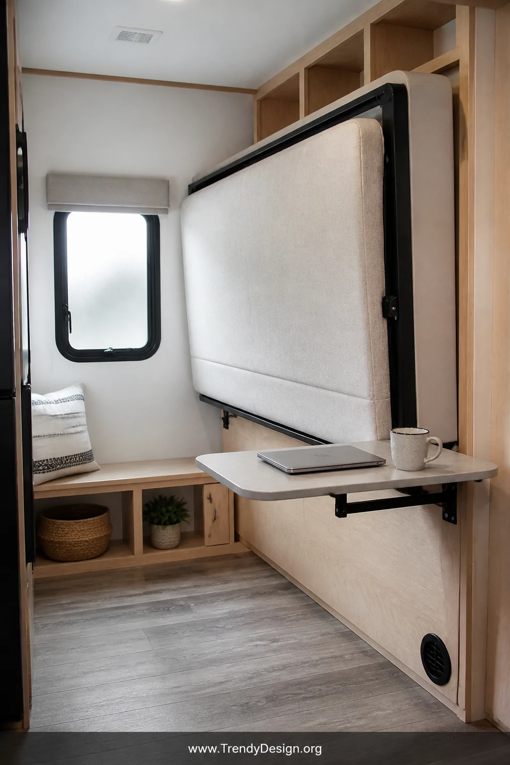 A medium photorealistic interior shot of an RV bunk room mid-transformation showing a fold-down Murphy-style bed mounted agai