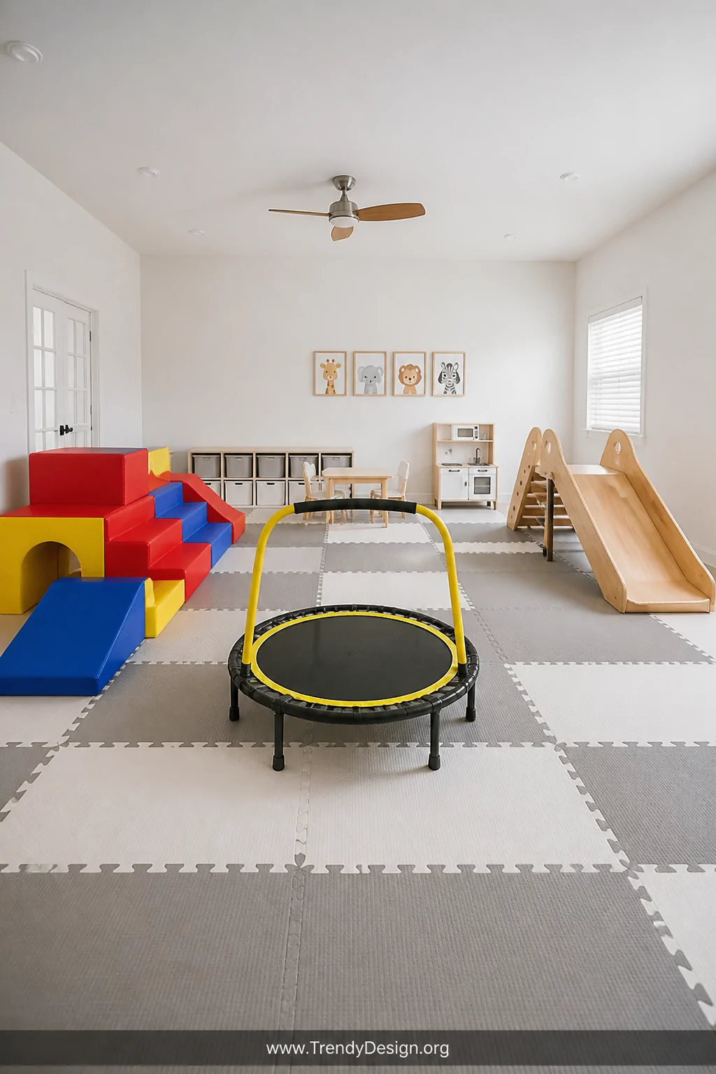 A bold toddler movement zone with a colorful foam climbing structure in primary red, blue, and yellow on thick interlocking f