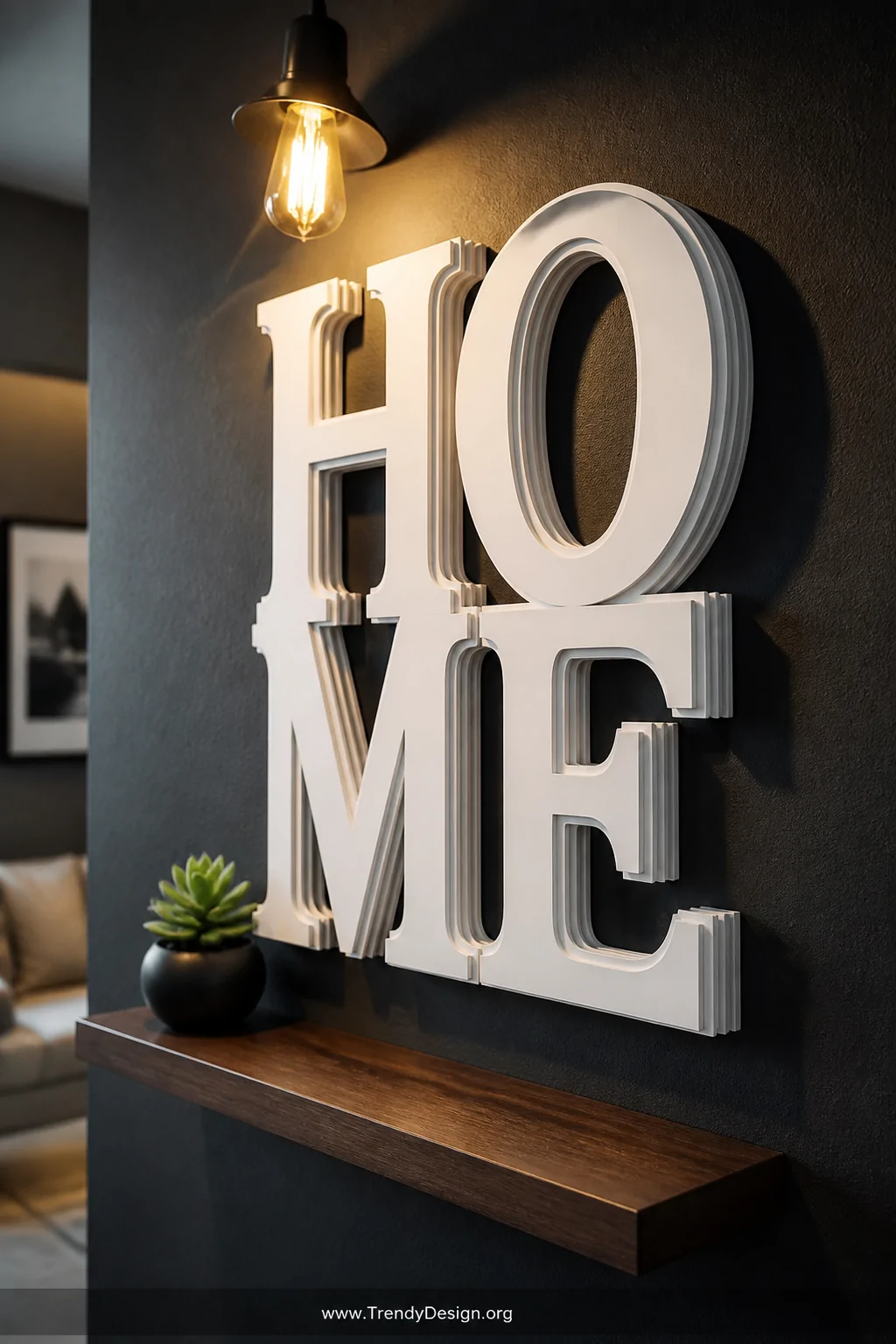 Closeup shot of a dimensional typographic quote display mounted on a deep charcoal accent wall, with the word HOME built from