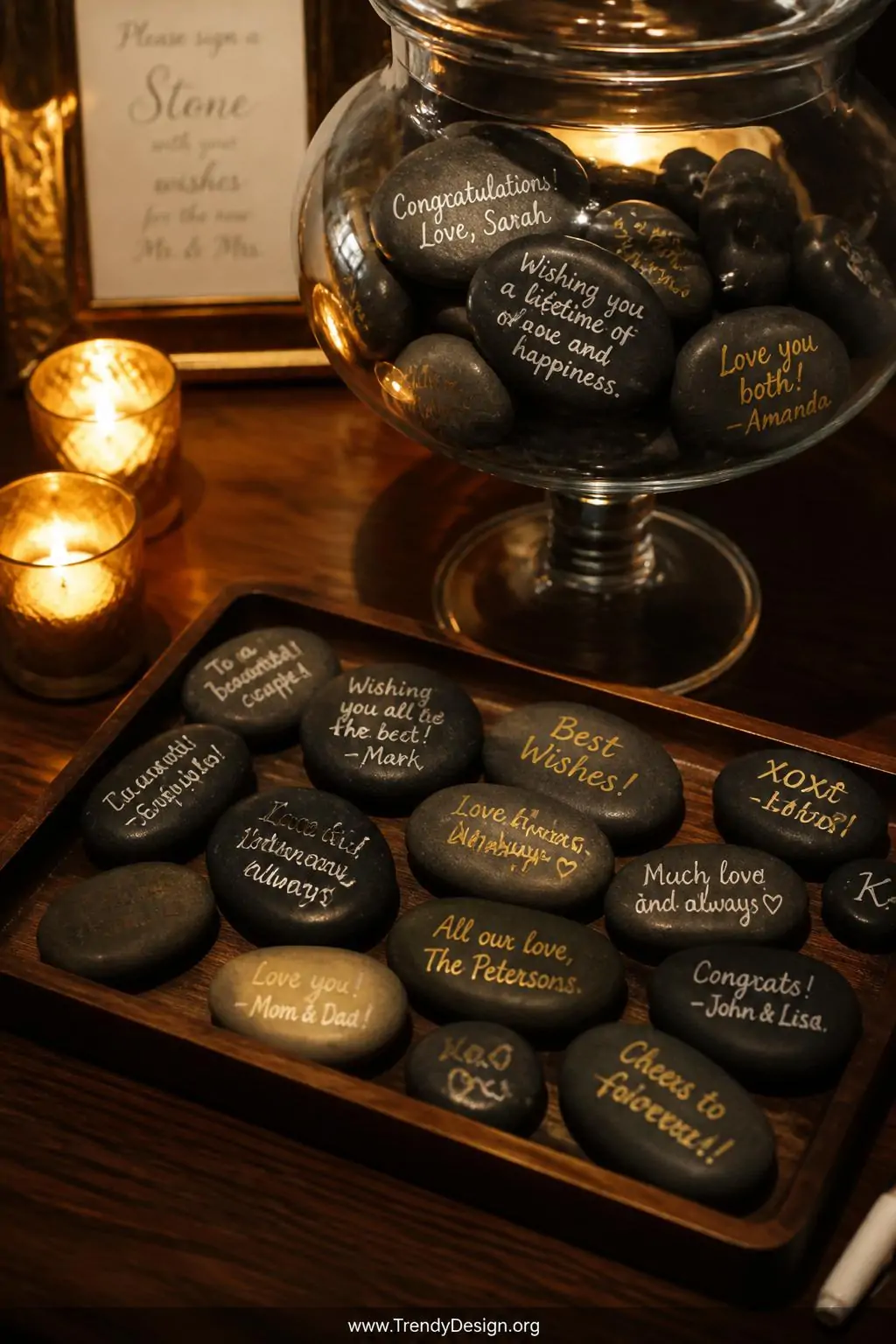 Closeup shot of a polished wooden tray holding dozens of smooth flat river stones with handwritten names and wishes in white 