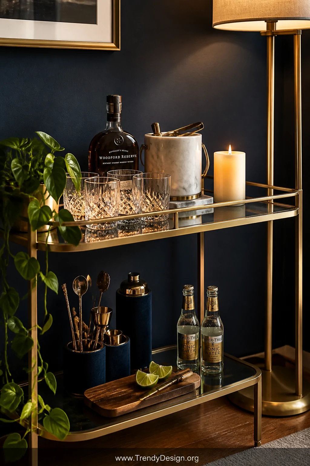 Closeup of a glamorous living room bar cart with a brushed brass frame, top shelf artfully styled with a cluster of crystal w