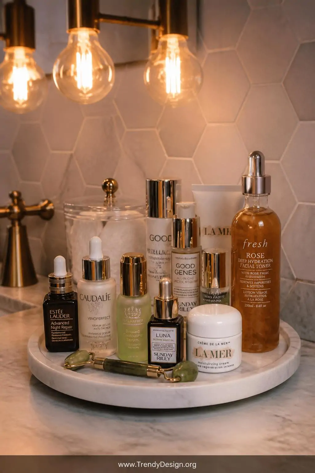 A glamorous close-up on a marble bathroom vanity displays a white marble-patterned lazy Susan carousel lined with apothecary-