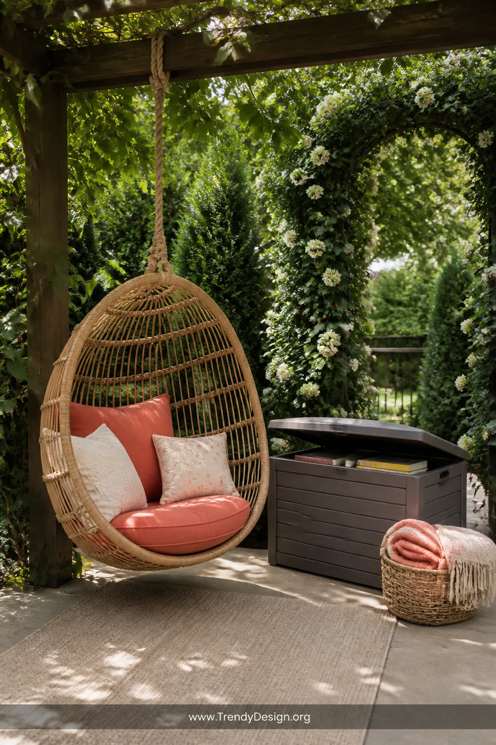 Wide-angle photorealistic outdoor shot of a garden reading corner on a shaded backyard patio, a natural rattan hanging swing 