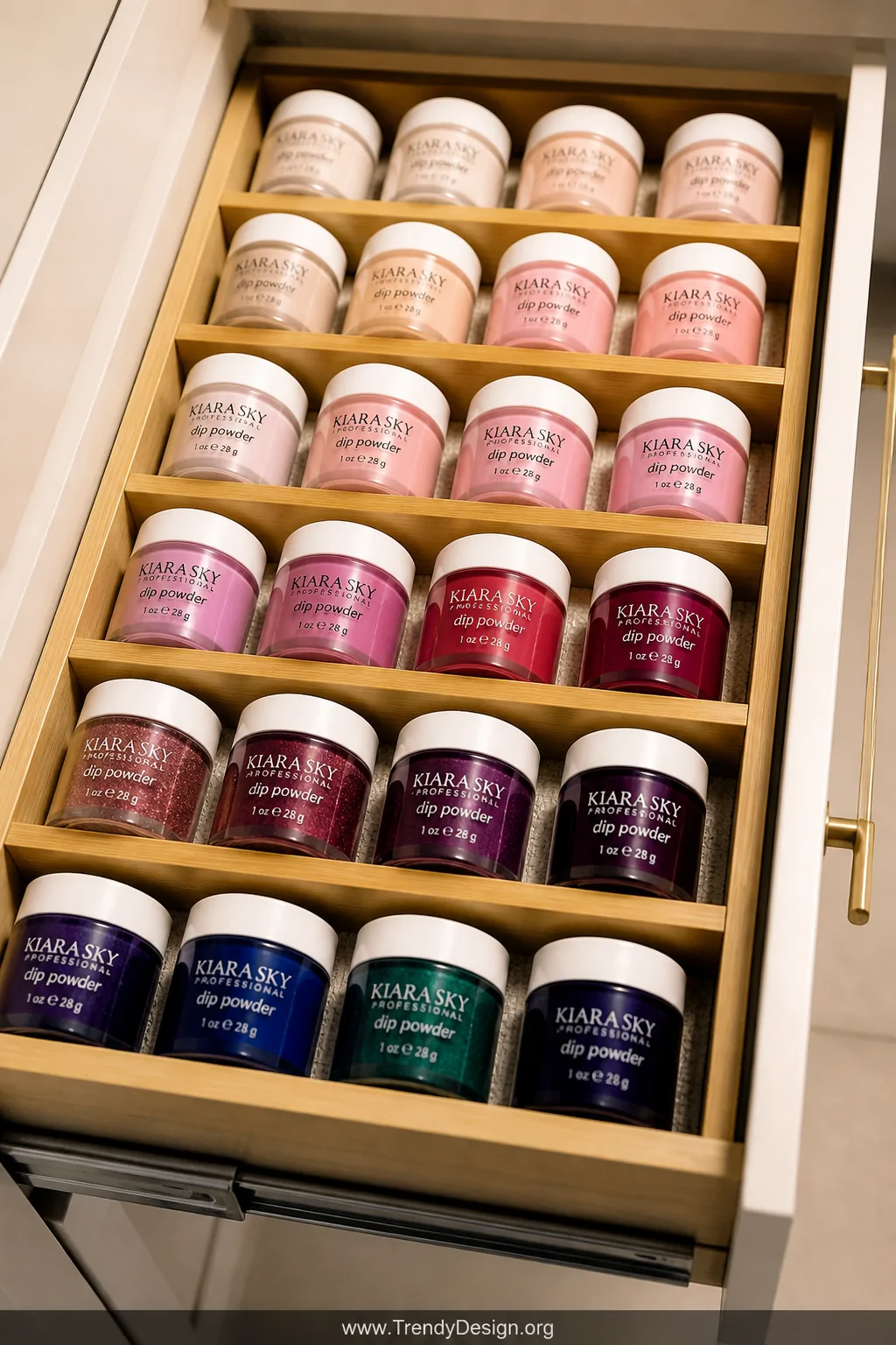 A close-up overhead detail shot of an open drawer lined with a pale gray non-slip mat, bamboo dividers creating precise compa