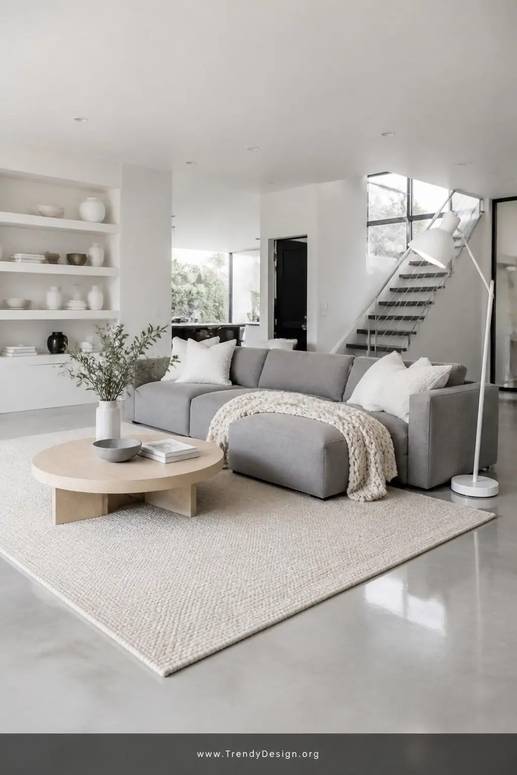 Wide-angle photorealistic interior shot of a clean airy minimalist living room with pale grey polished floors and a smooth mi