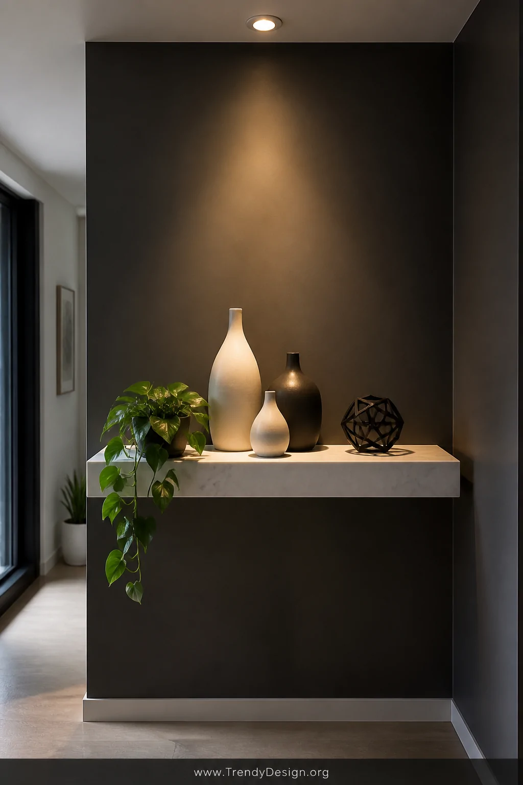 Medium shot of a single narrow white marble floating shelf mounted on a deep charcoal accent wall in a minimalist entryway, h
