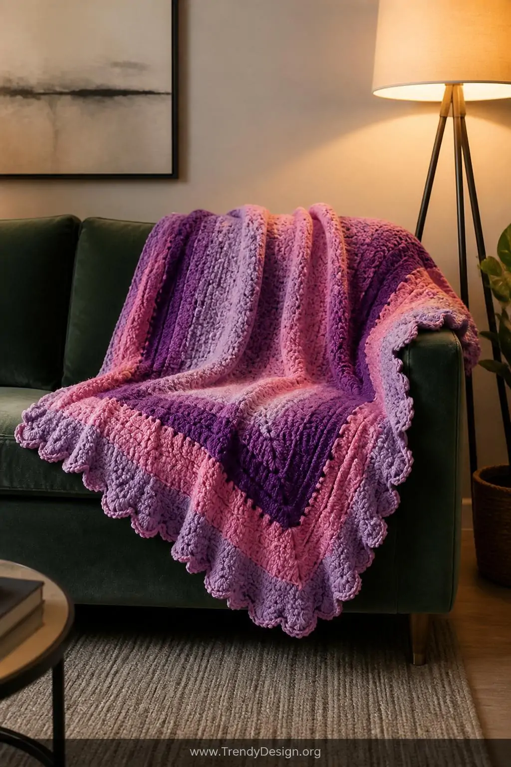 A medium photorealistic interior shot of a flowing C2C blanket casually draped over a velvet sage green sofa, its lavender an