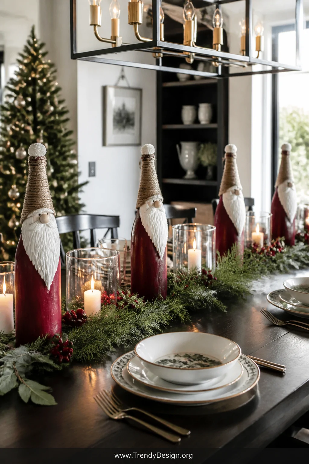 A wide dining room shot featuring tall wine bottle Santa centerpieces painted deep red with white dimensional paint beards, f