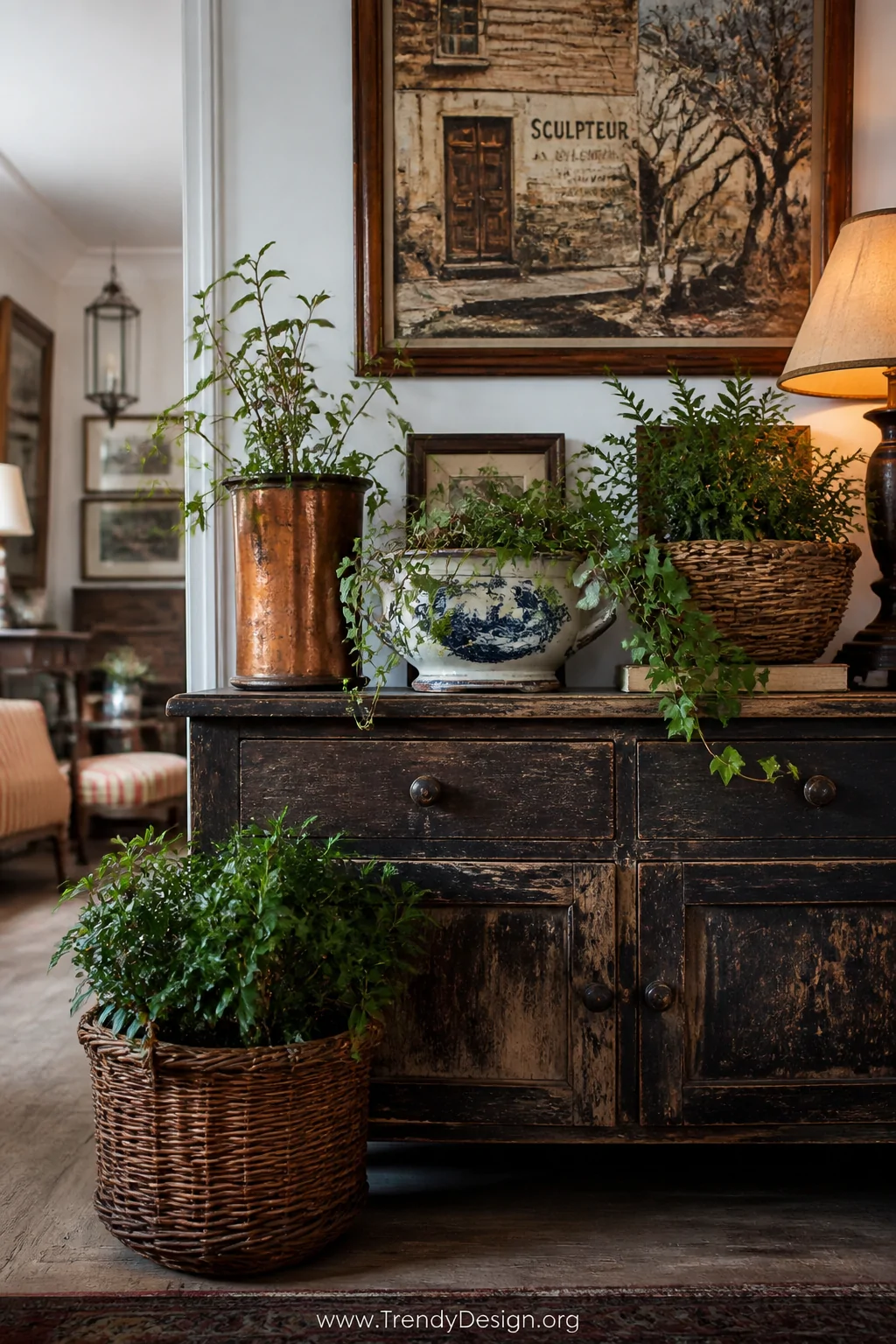 A wide room shot of an eclectic living space vignette featuring an assortment of repurposed vintage vessels used as planters 