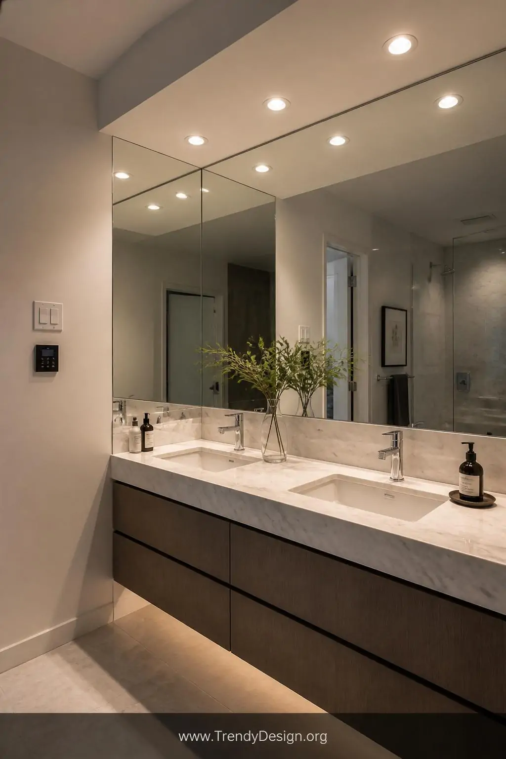 A medium-shot overhead view of a sophisticated bathroom vanity where strategically positioned recessed ceiling lights sit pre