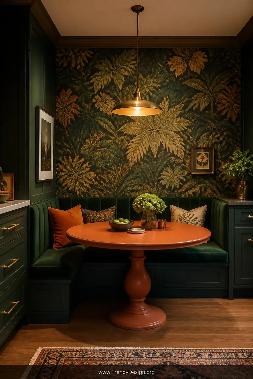 Wide shot of a bold jewel-toned kitchen banquette nook featuring deep emerald velvet bench cushions, a round painted terracot