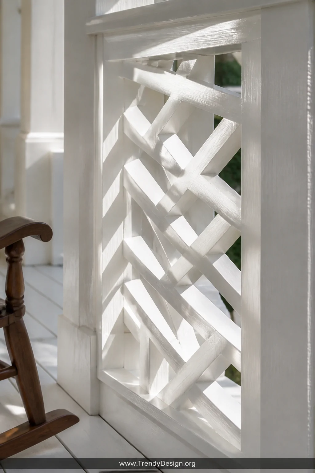 Detail closeup of a white-painted Chippendale-style wood railing panel, intricate geometric diagonal lattice pattern casting 