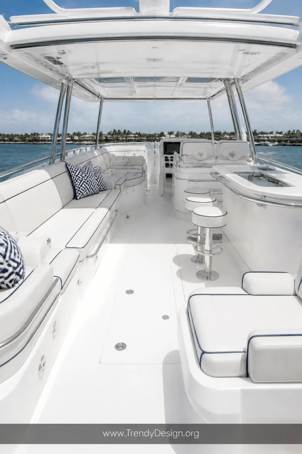Wide shot of a jaw-dropping all-white boat interior with bright white cushions and slightly warm off-white cream backrests tr