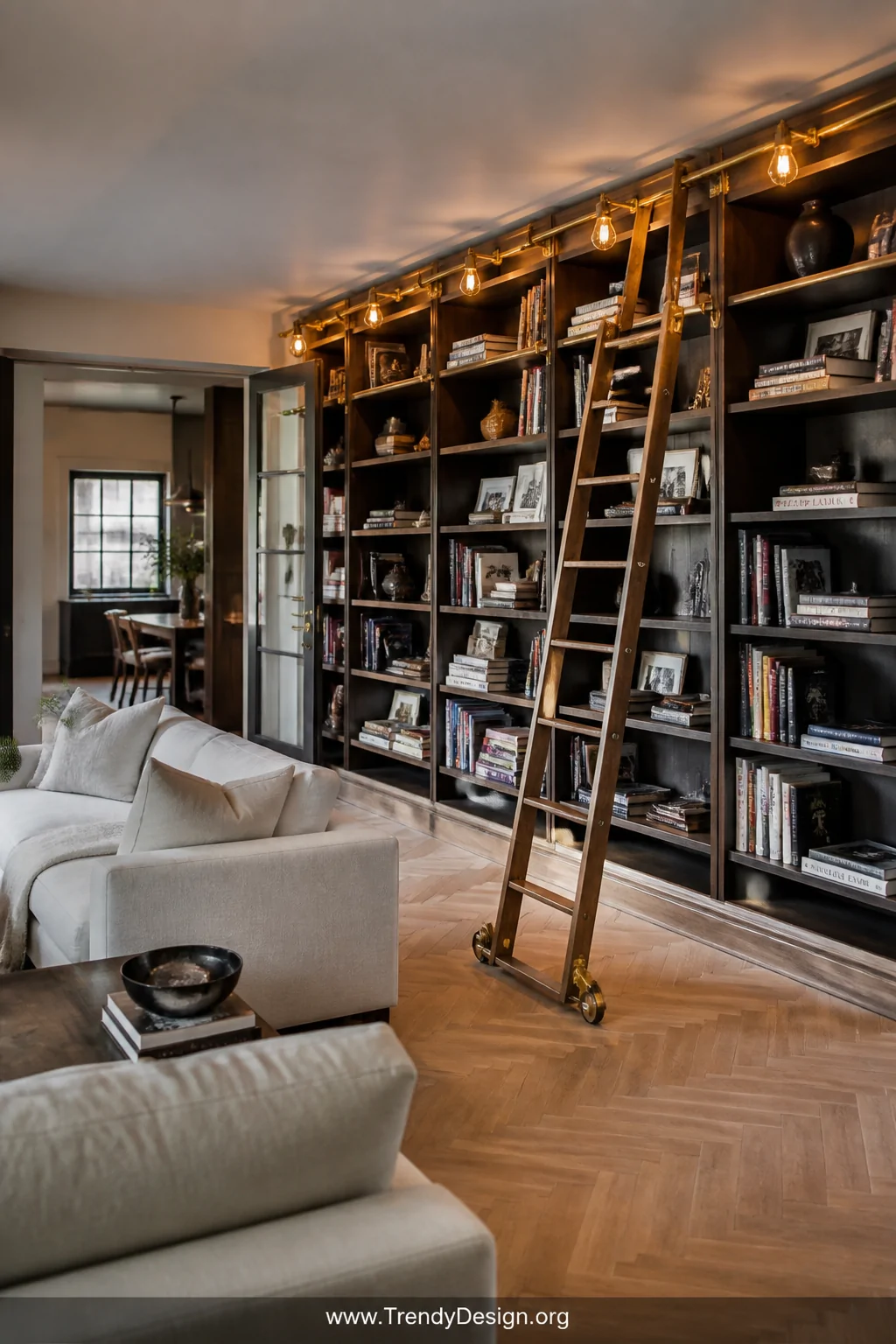 Wide photorealistic interior shot of an open-plan living room featuring floor-to-ceiling shelving along one wall lined with b