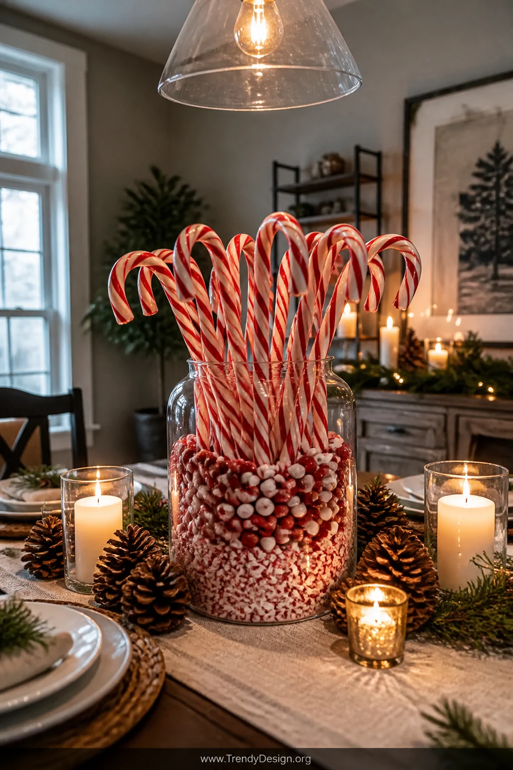 A wide room shot of a broad clear glass jar on a holiday dining table with full-size candy canes standing upright fanning out
