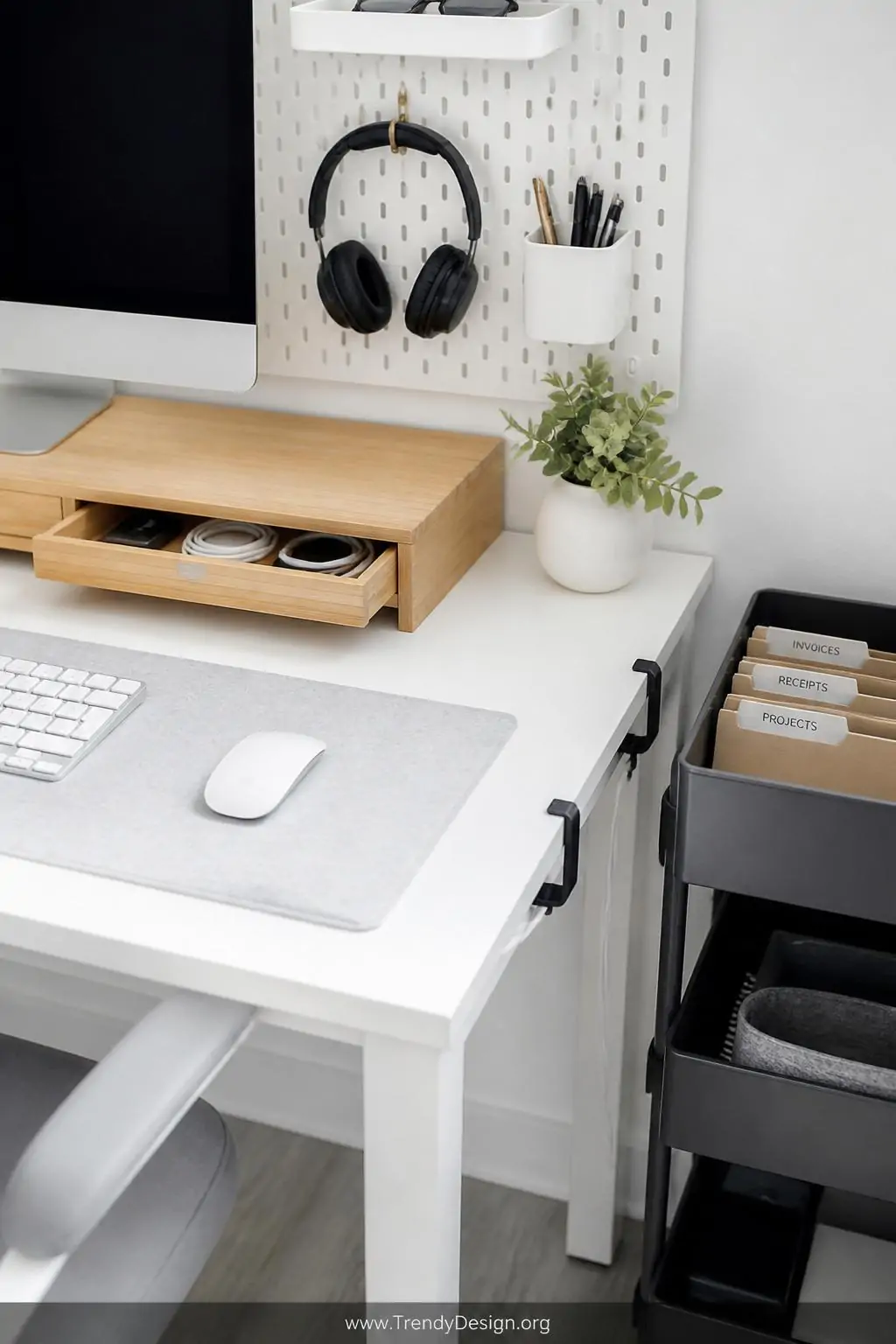 Close-up photorealistic interior shot of an immaculately organized compact white desk surface featuring a bamboo monitor rise