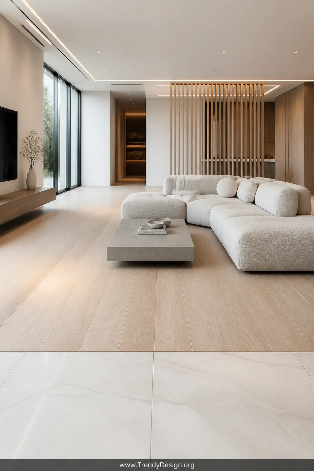 Wide room shot of a sleek minimalist living space with a flush-mount transition system completely level between pale large-fo