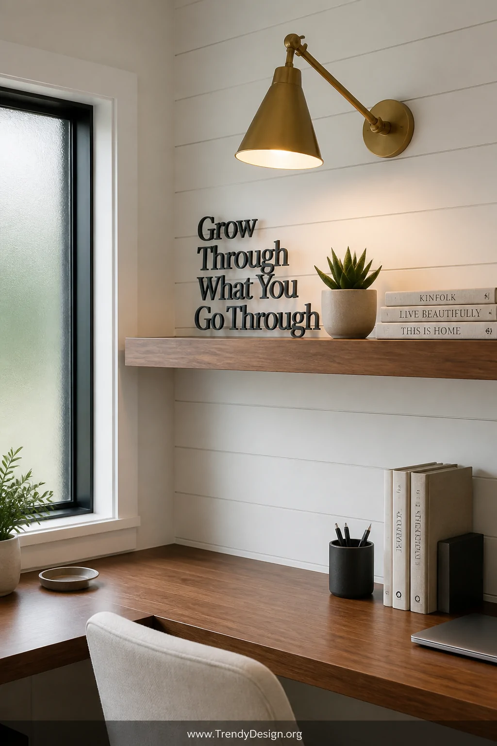 Medium shot of a bright home office nook with white shiplap walls, a floating walnut shelf holding stacked linen books and a 