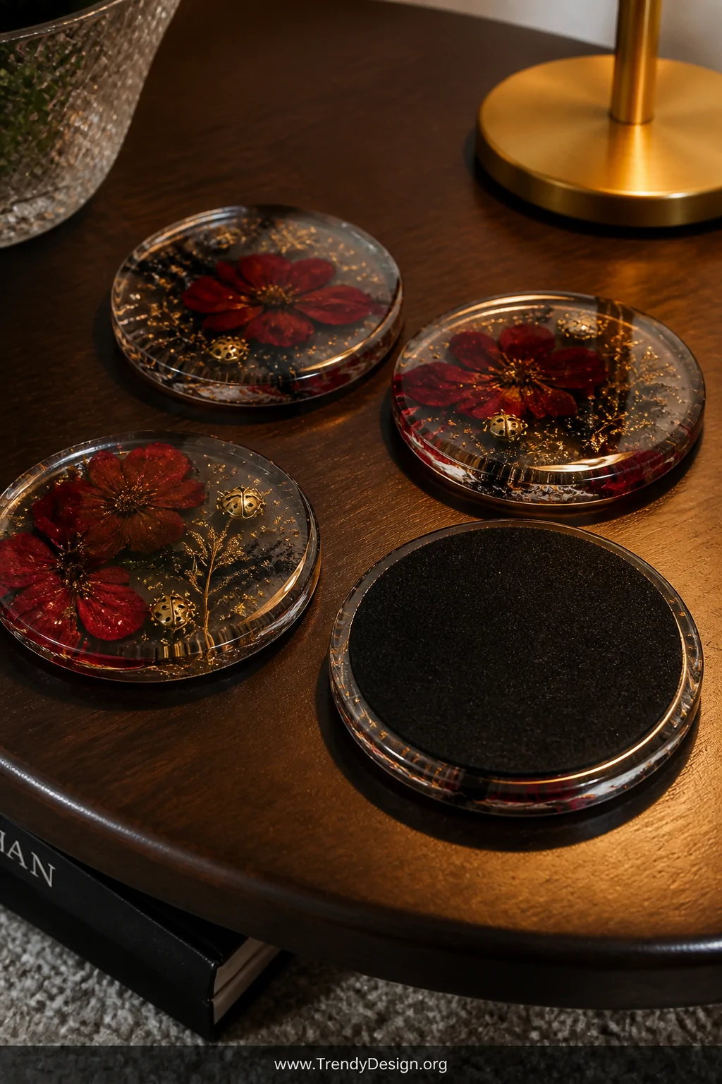 A close-up detail shot of four round resin coasters arranged on a dark walnut coffee table, each one filled with suspended dr