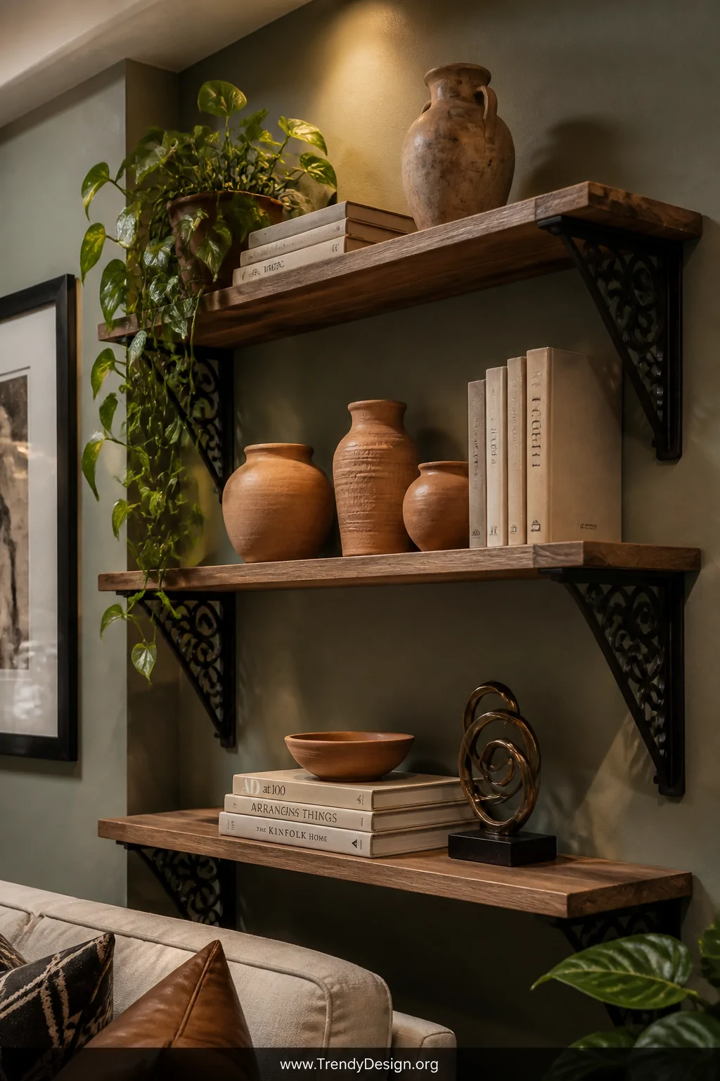 Medium shot of a styled living room wall featuring floating shelves supported by elegant CNC-engraved powder-coated steel bra